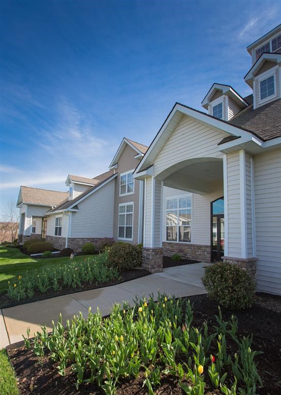 a white house with a sidewalk in front of it