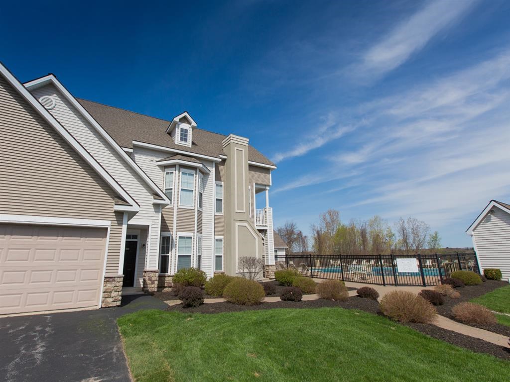 a house with a yard and a pool in front of it