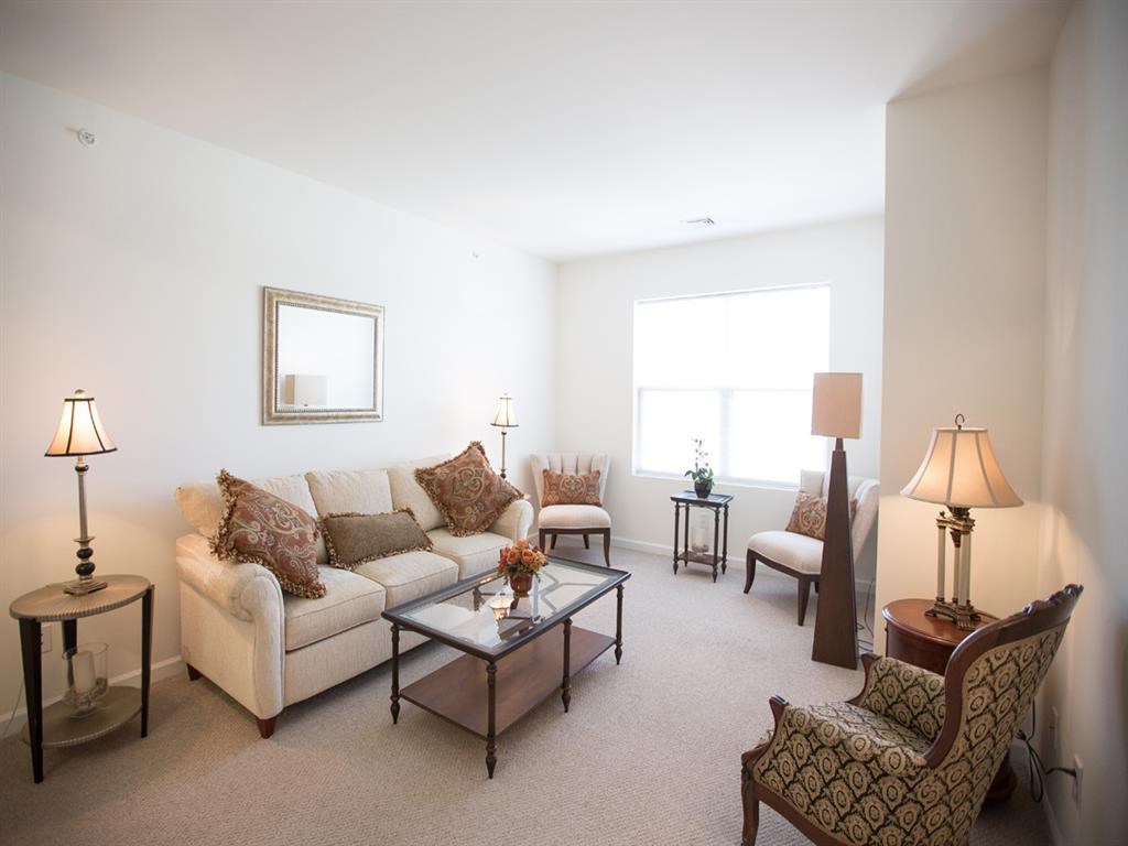 a living room with a couch and chairs and a table