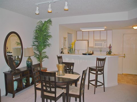 a dining room and kitchen with a table and chairs