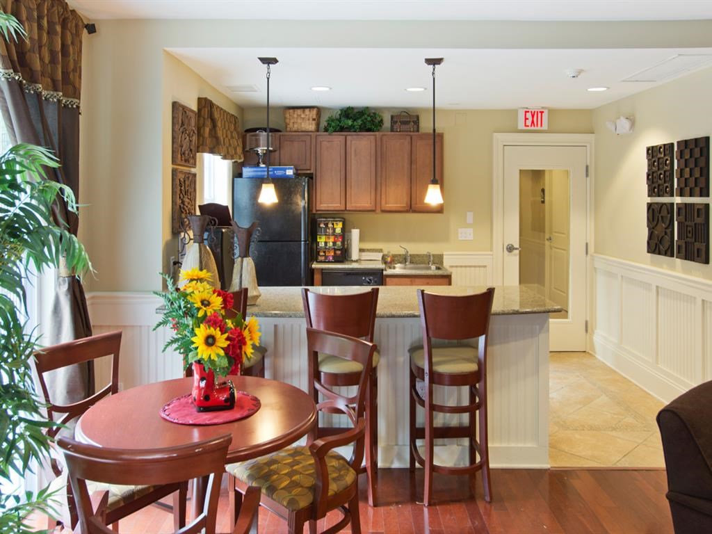 a kitchen and dining room with a table and chairs