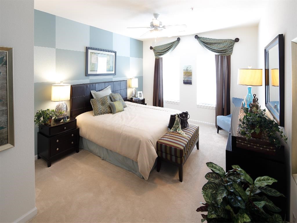 a bedroom with a bed and a couch in it