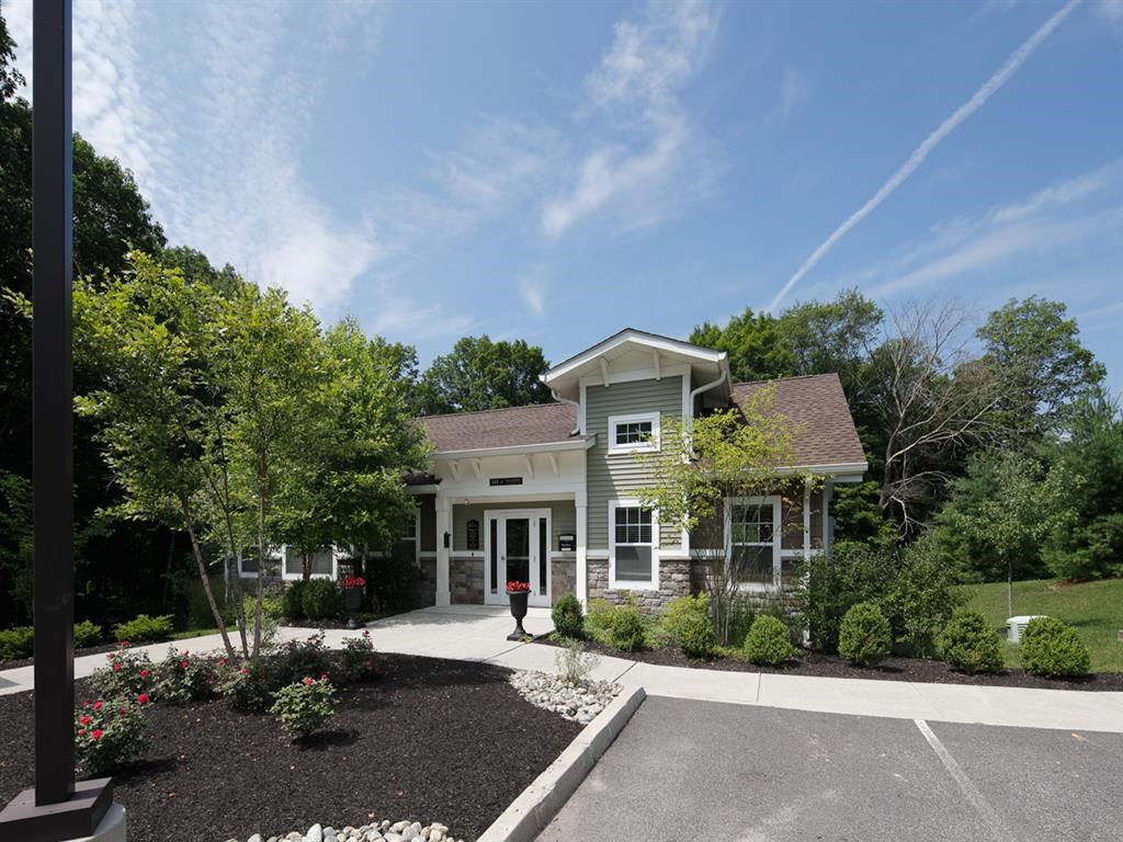 the front of a house with a driveway and landscaping
