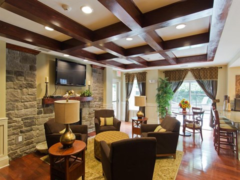 a living room with a stone wall and a tv