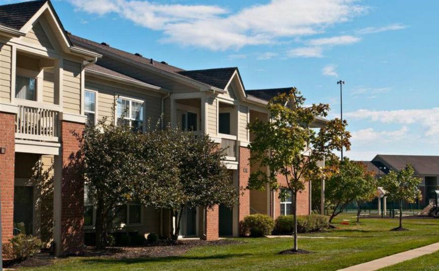 Apartment building exterior with trees and landscaping