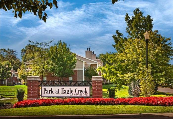 Outdoor signage for community entrance reads park at eagle creek
