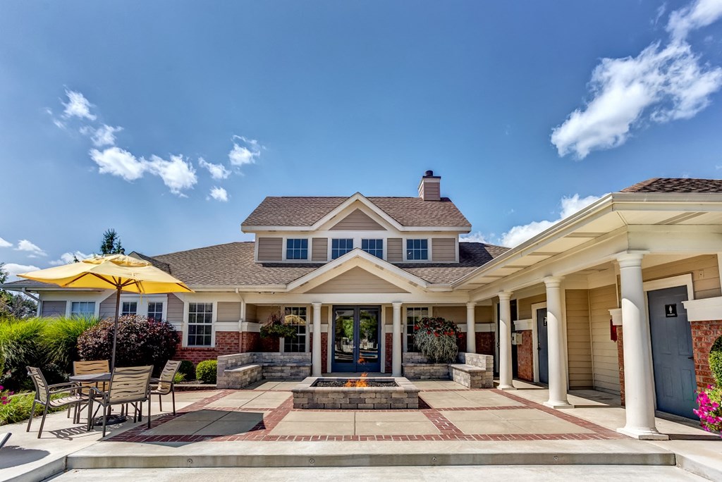 Clubhouse exterior with seating area and fire pit close to Eagle Creek Park and Downtown Indianapolis