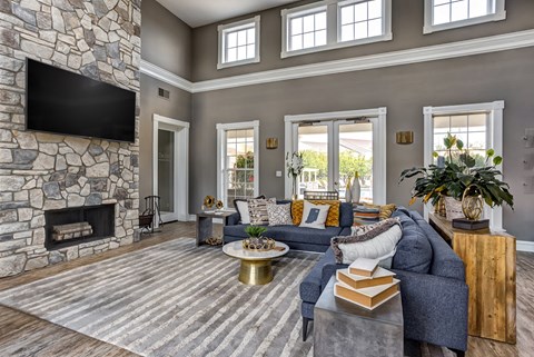 a living room with a stone fireplace and a blue couch