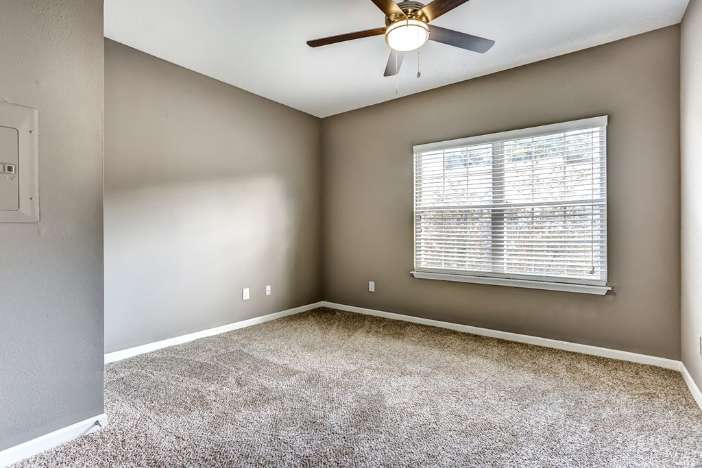 Upgraded bedroom with neutral paint, carpet, and ceiling fan