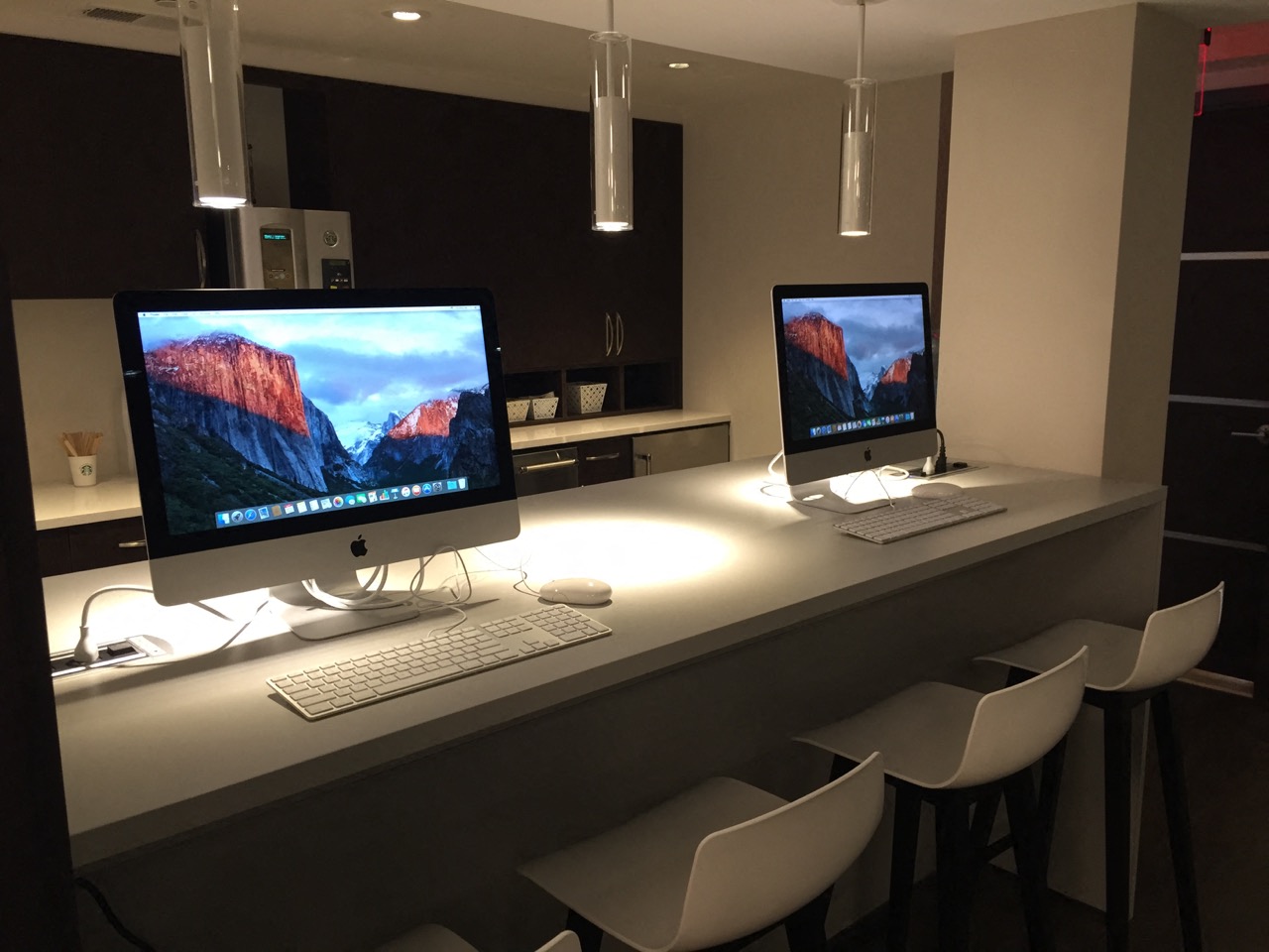 a desk with two computer monitors and a keyboard on it