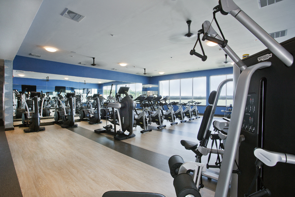 a gym filled with cardio machines and weights
