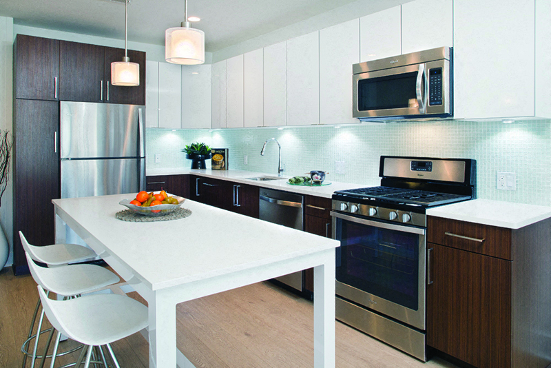 a kitchen with stainless steel appliances and a white table