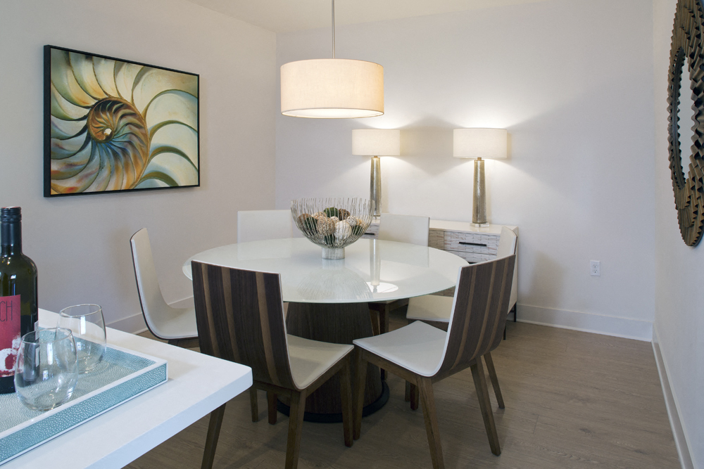 a dining room with a table and chairs and a lamp