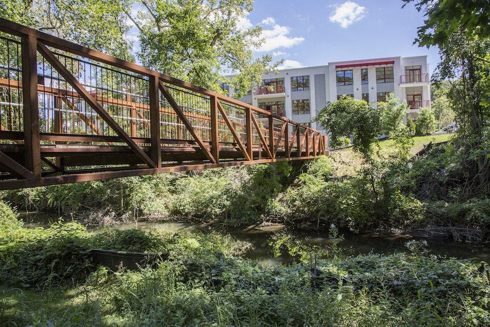 a bridge over a river with buildings in the background