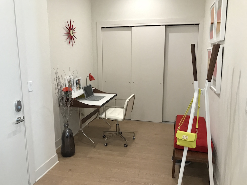 a room with a desk and a chair and a door