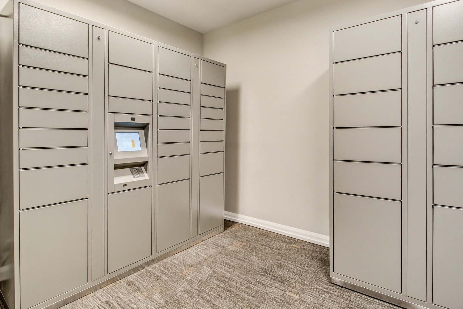 A row of grey lockers with a keypad on the doors.