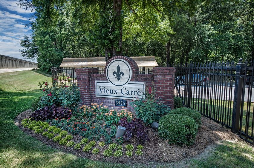the sign for new center at the entrance of a park with a fence