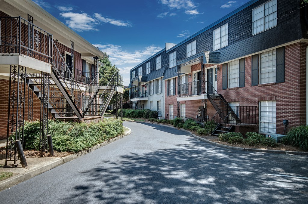 an empty street in front of a row of apartment buildings