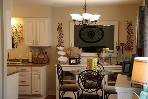 a kitchen and dining room with a table and chairs