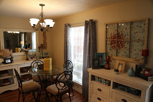 a dining room with a table and chairs and a chandelier