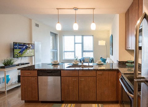 A modern kitchen with wooden cabinets and a large island.