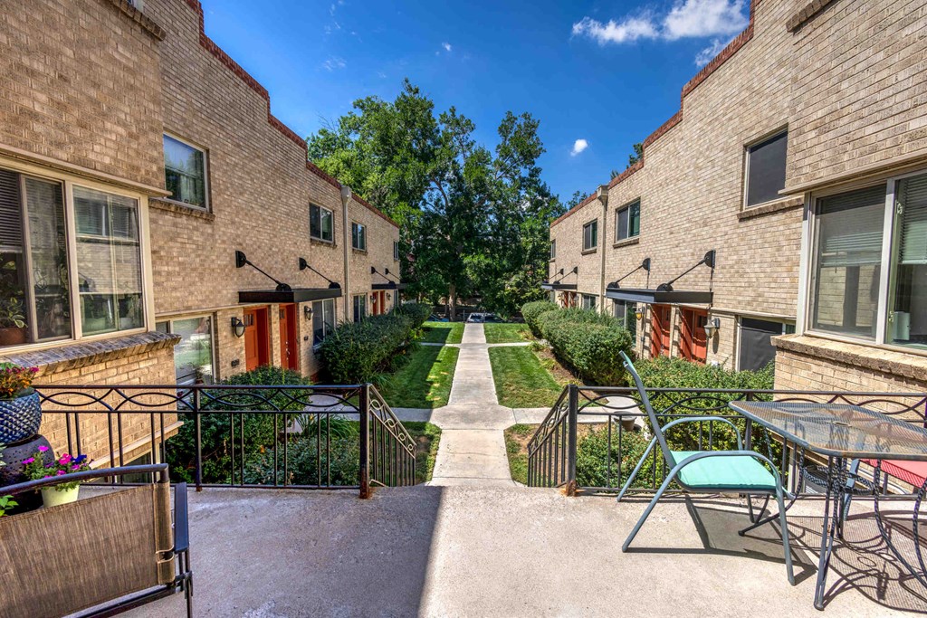 a courtyard with tables and chairs in the middle