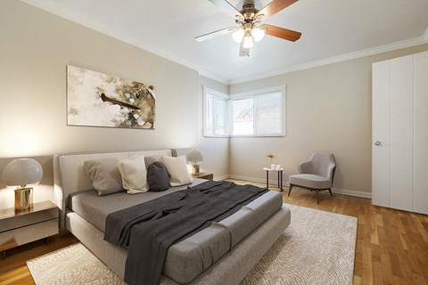 a bedroom with a bed and a ceiling fan