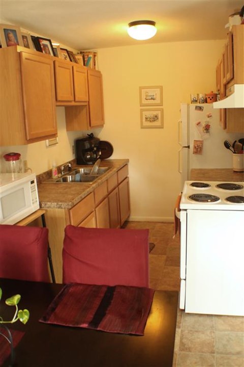 a small kitchen with a table and chairs