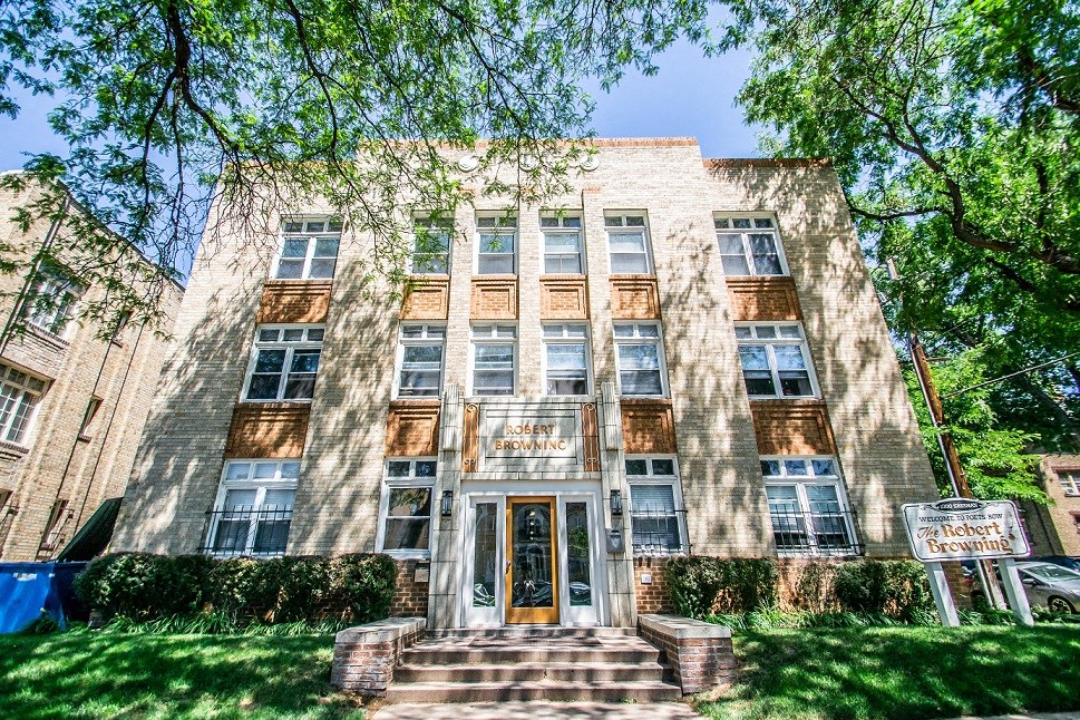 a large brick building with trees in front of it