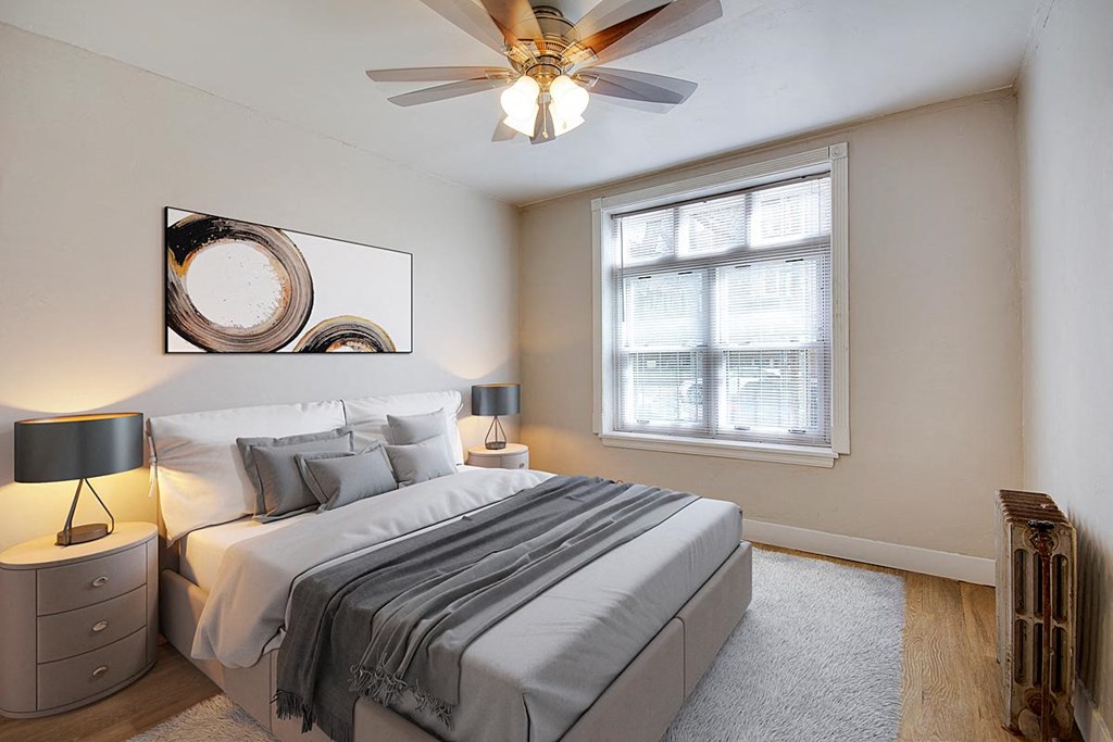 a bedroom with a bed and a ceiling fan