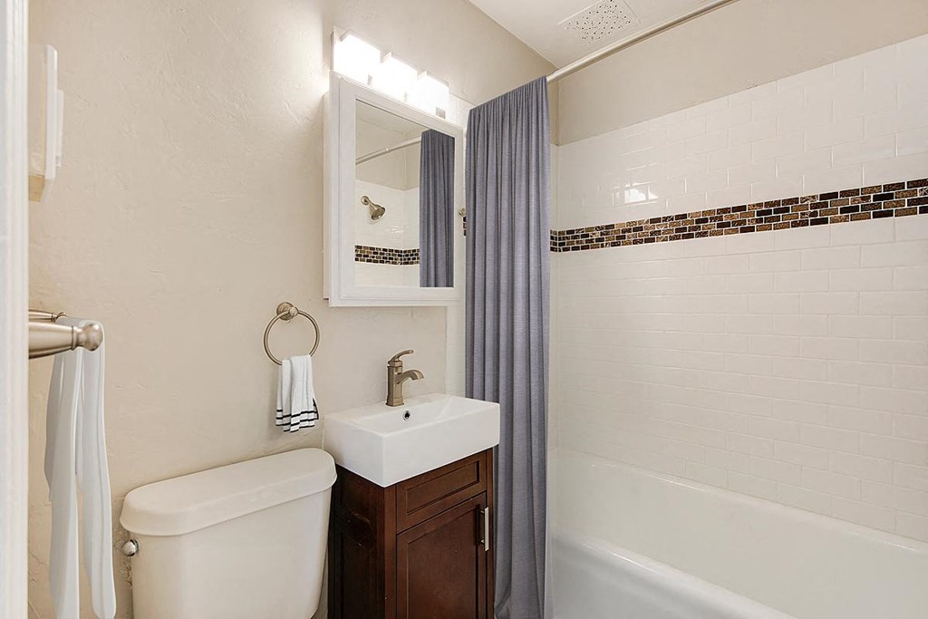 a bathroom with a toilet and a sink and a shower