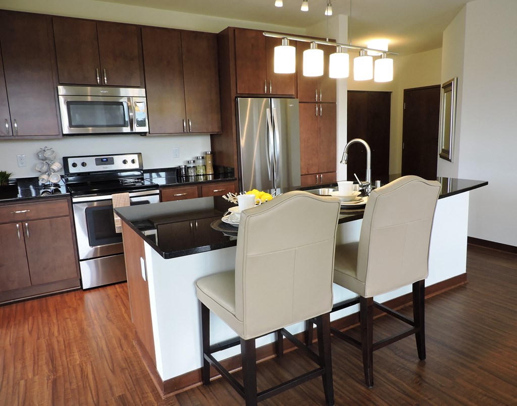 a kitchen with a island and a table with chairs