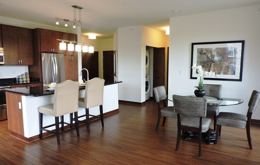 a kitchen and dining room with a table and chairs