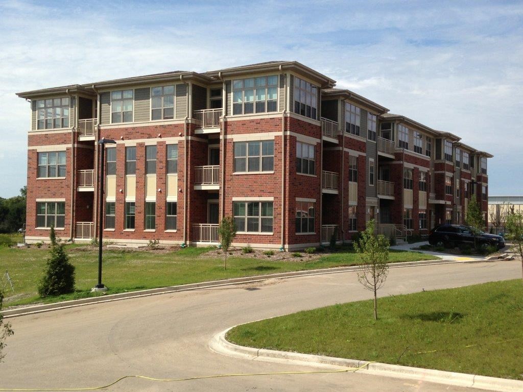 an apartment building on the corner of a street