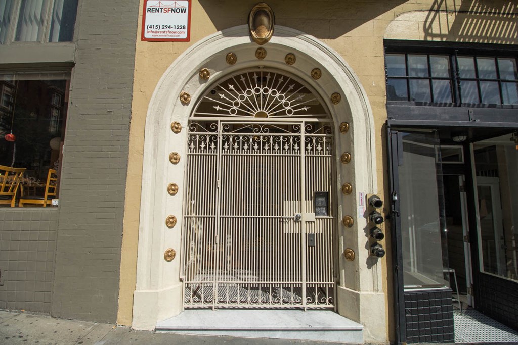 A building with a large gate and a sign that says RentFnow.
