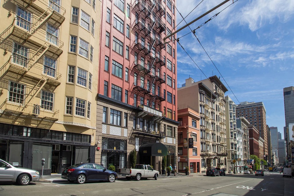 A street view of a city with cars and buildings.