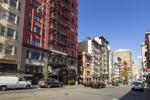 A city street with cars and buildings.