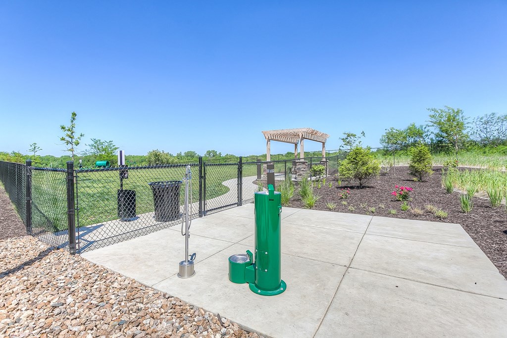a fenced in area with a water fountain and trash cans at EdgeWater at City Center, Lenexa, KS, 66219