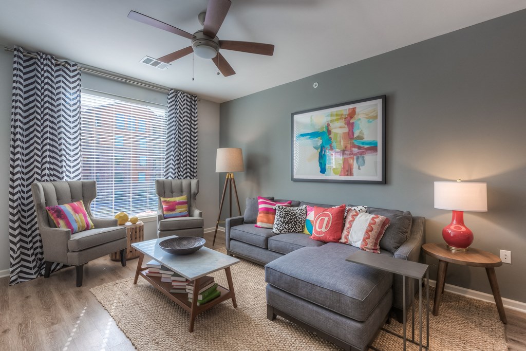 a living room with gray walls and a ceiling fan  at EdgeWater at City Center, Lenexa, KS, 66219