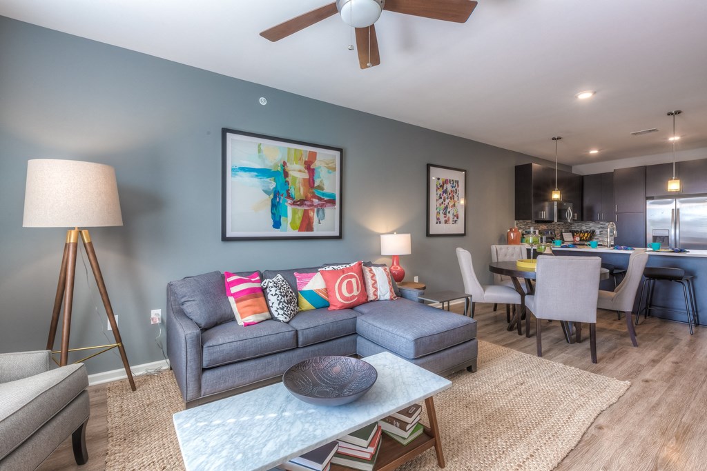 living room with couch and ceiling fan and dining room table  at EdgeWater at City Center, Lenexa, 66219