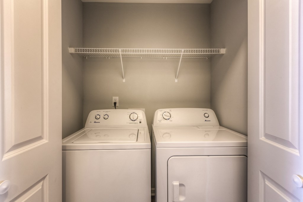 a washer and dryer in the laundry room of a house  at EdgeWater at City Center, Lenexa, KS