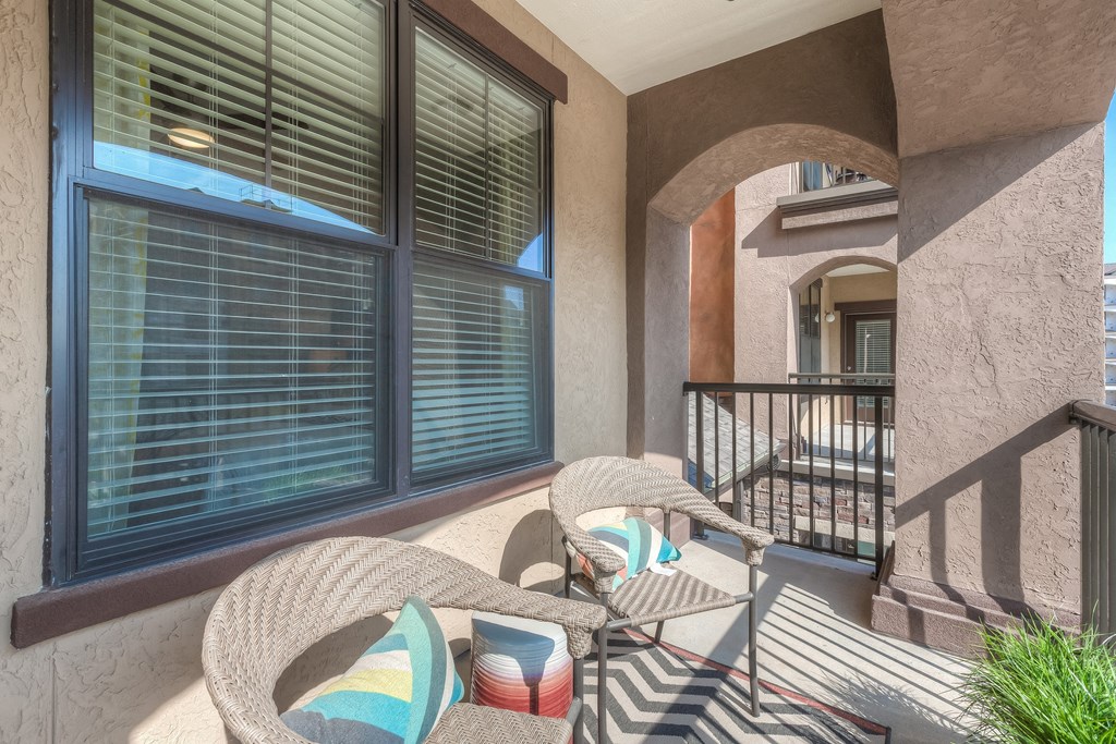 a patio with two chairs and a table  at EdgeWater at City Center, Lenexa, 66219