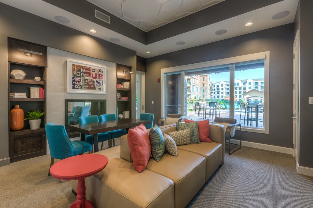 a living room filled with furniture and a large window  at EdgeWater at City Center, Lenexa, 66219