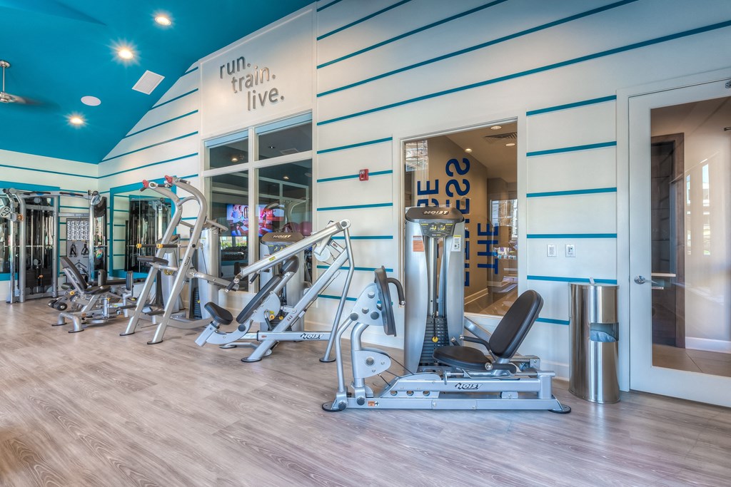 a gym with a variety of exercise equipment  at EdgeWater at City Center, Lenexa, Kansas
