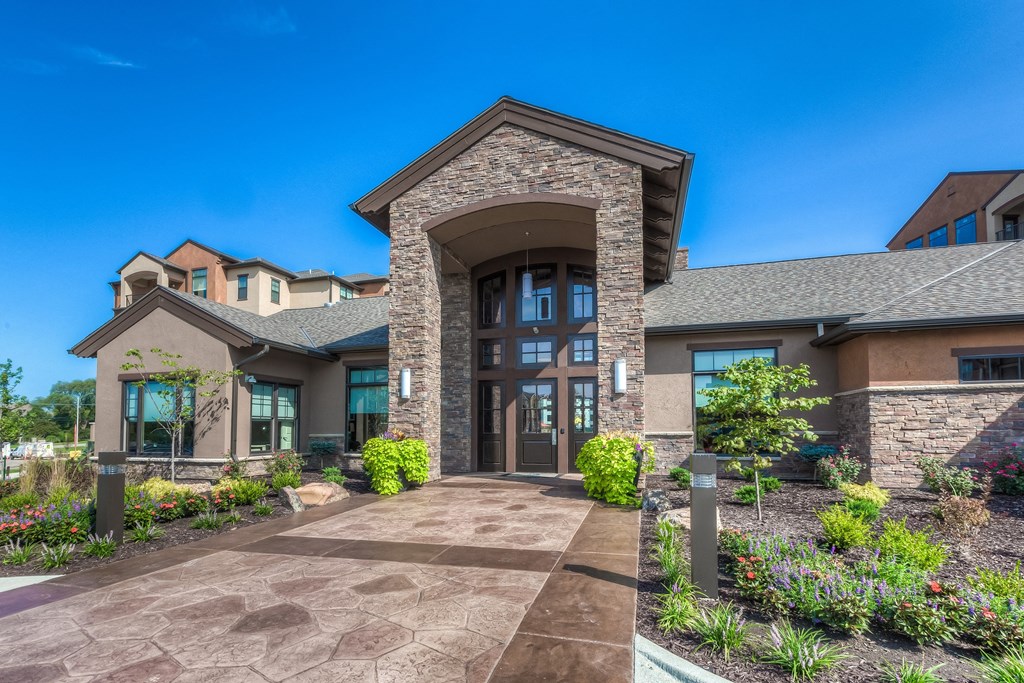 a building with a walkway in front and landscaping  at EdgeWater at City Center, Lenexa, KS