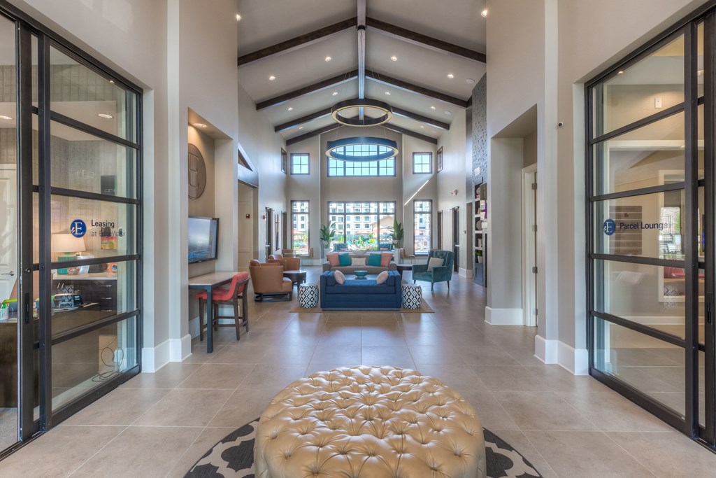 clubhouse with couch and chaise in middle and glass doors  at EdgeWater at City Center, Lenexa, 66219