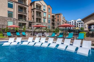 loungers in pool and umbrellas with chairs  at EdgeWater at City Center, Kansas - Photo Gallery 5