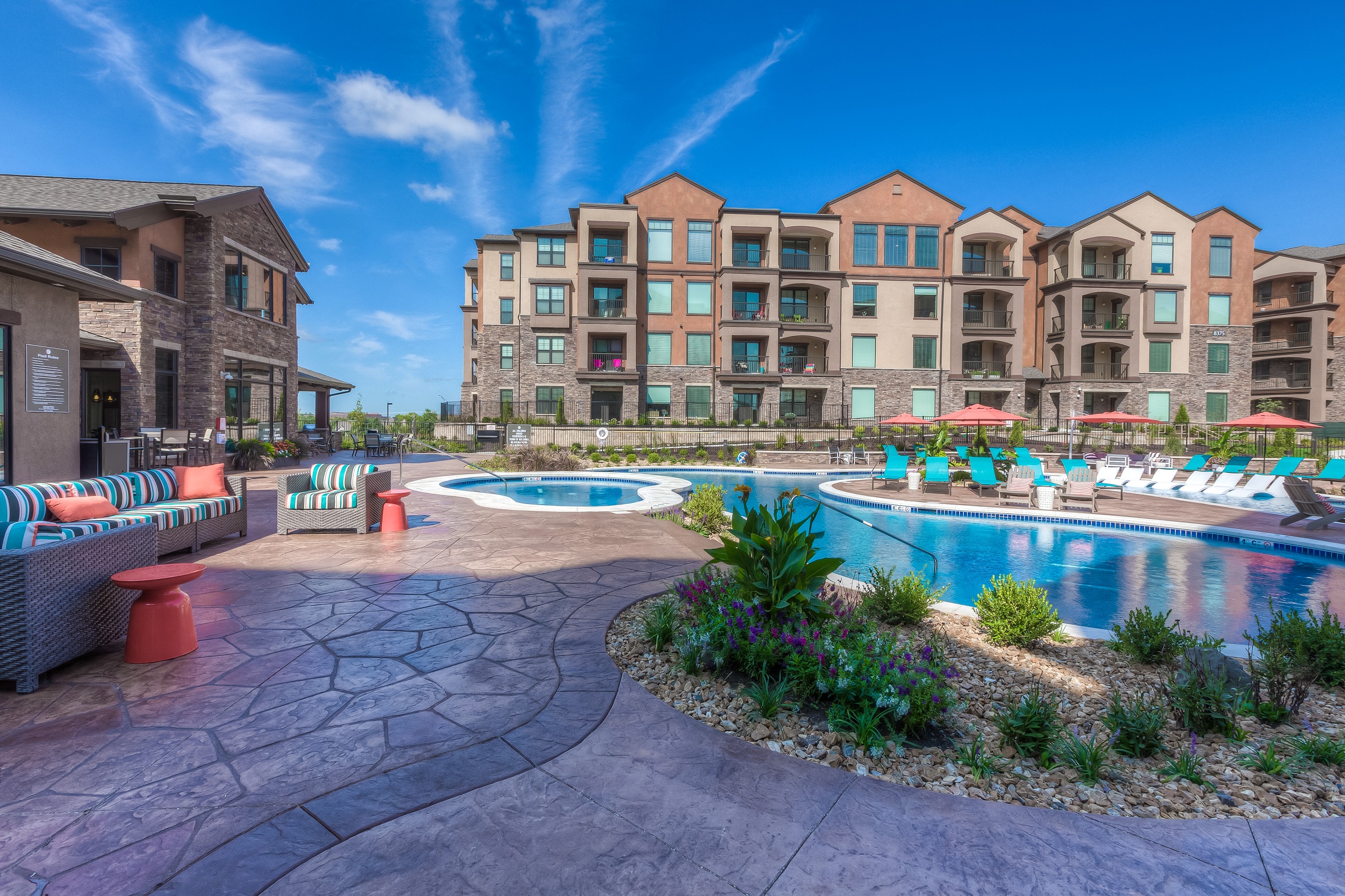 a resort style swimming pool with lounge chairs and chaise lounge chairs  at EdgeWater at City Center, Kansas, 66219