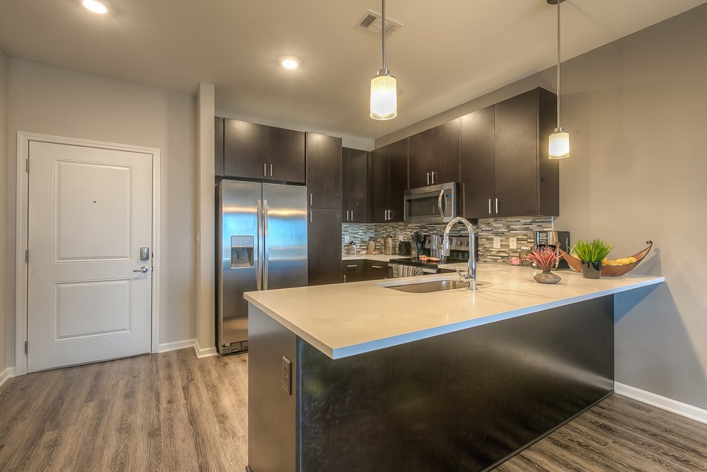 a kitchen with a large counter space and stainless steel appliances  at EdgeWater at City Center, Lenexa, 66219