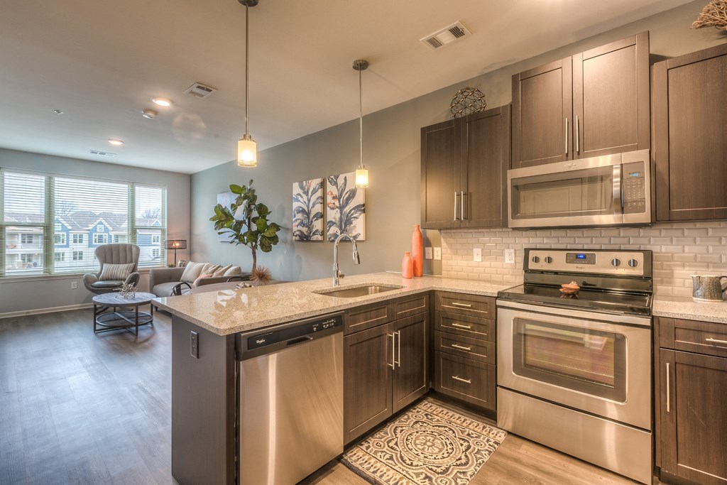 a kitchen with stainless steel appliances and a granite counter top  at Waterside Residences on Quivira, Lenexa, 66215